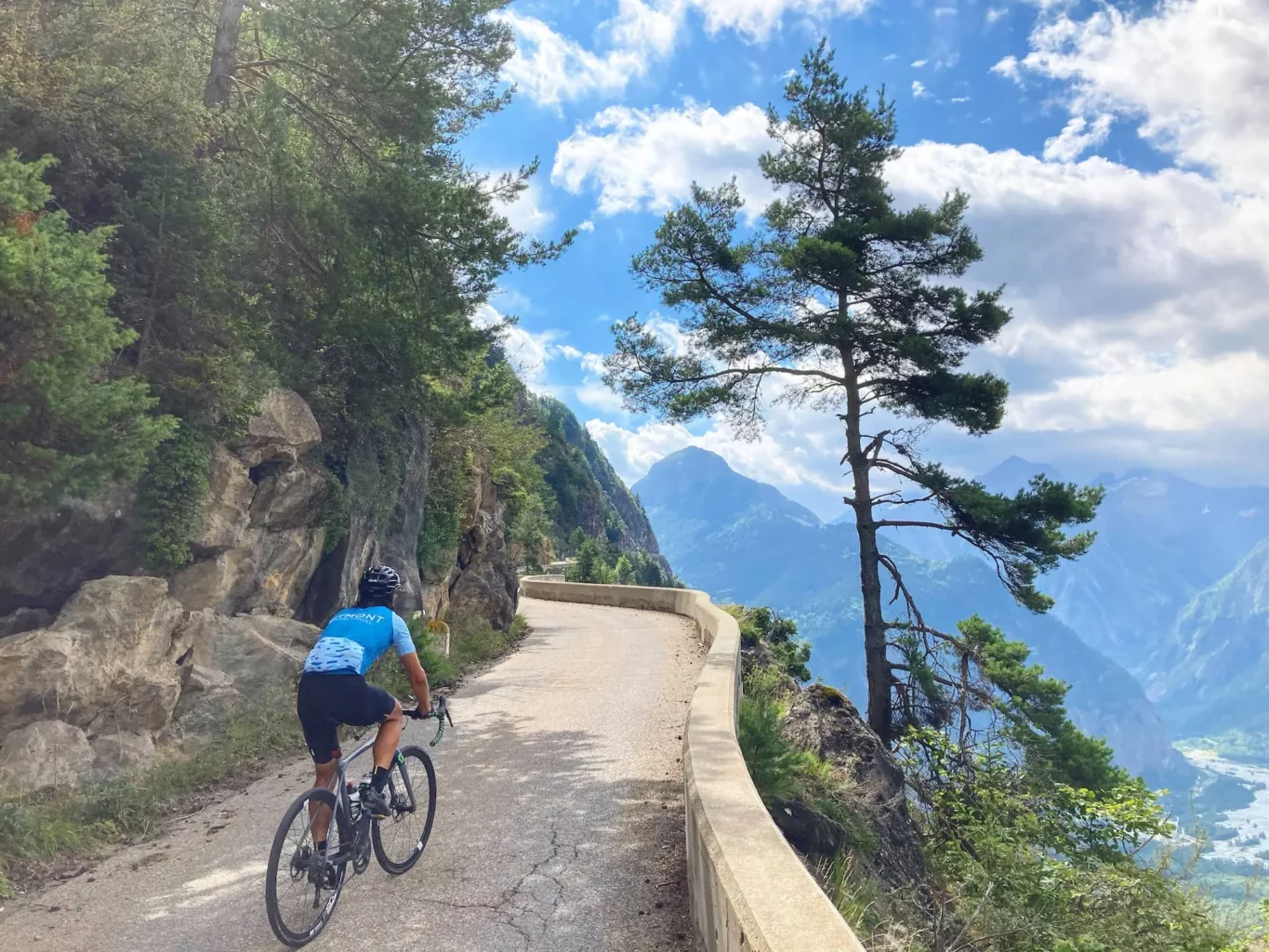 A cyclist traveling with Veymont Travel, exploring the Balcons d'Auris in the Oisans region, near Alpe d'Huez, in the French Alps