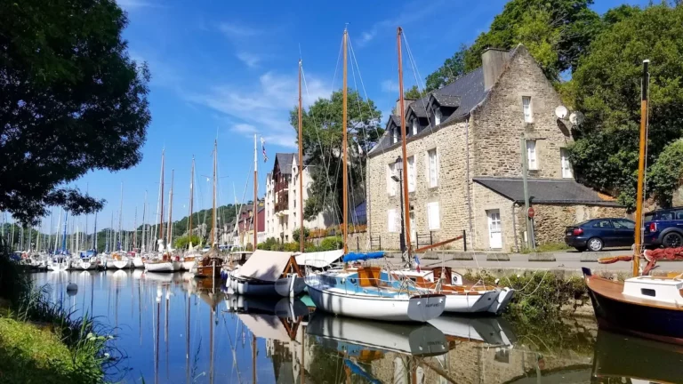 a small Breton harbor with sailboats moored