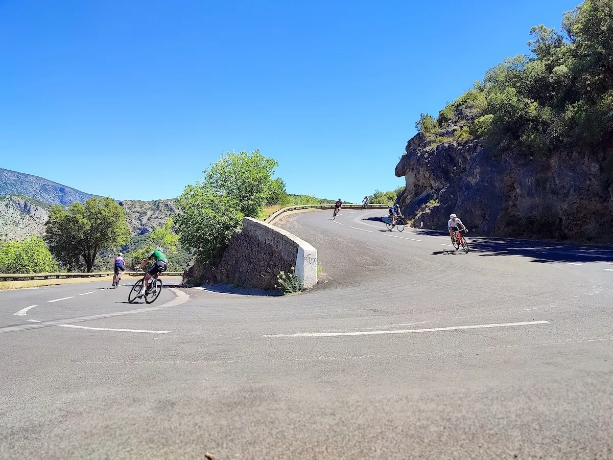 Group of cyclists traveling with Veymont Travel descends the Cirque de Navacelles
