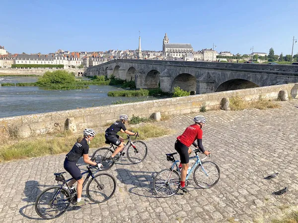 Cyclists riding along the Loire River in Blois during a cycling trip in the Loire Valley with Veymont Travel