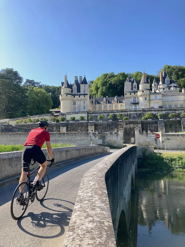 A cyclist traveling with Veymont Travel passes near the Château d'Ussé in the Loire Valley.