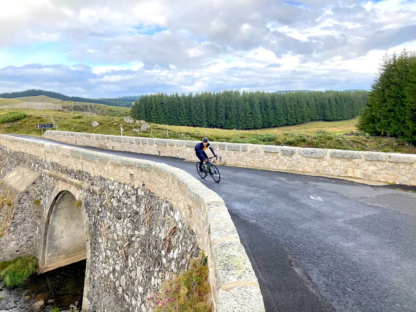 Cyclist on a bridge in the Massif Central