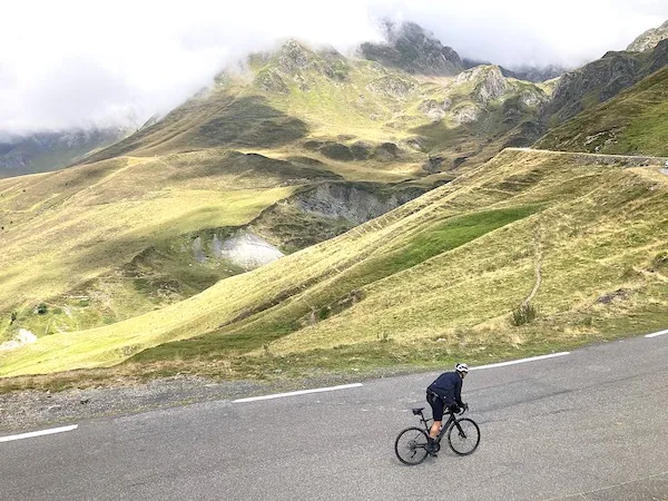 Cyclist climbing Tourmalet pass in the Pyrenees